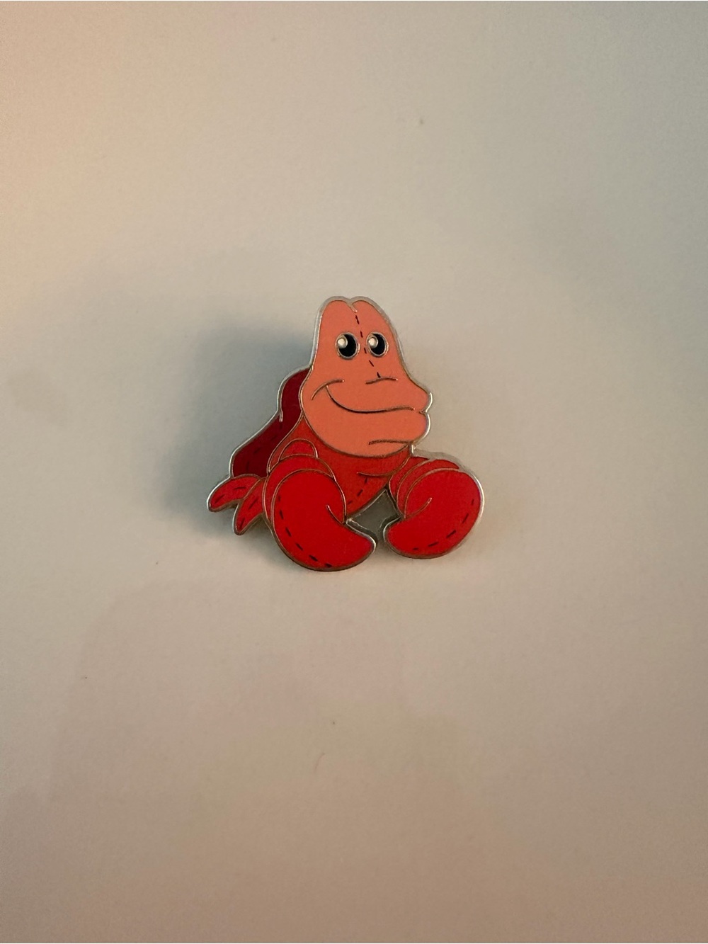 Disney Pixie Plush Mystery Pin featuring Sebastian from The Little Mermaid.